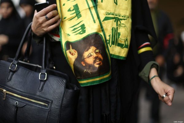 A woman wears a scarf decorated in the colours of Lebanon's Shia Hezbollah movement and bearing a picture of the movement's leader Hassan Nasrallah in a Beirut southern suburb on October 12, 2016