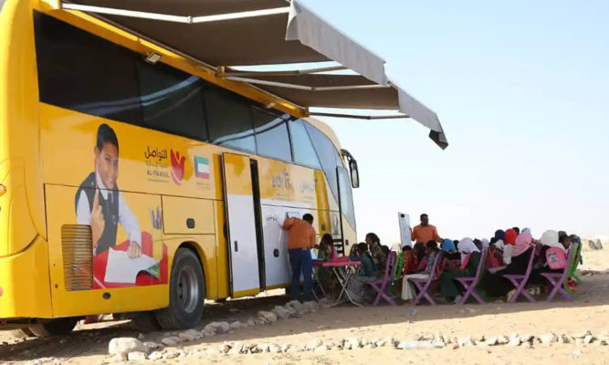 Displaced children in Yemen enjoy lessons under the shade of the awnings of the roaming school bus. Photograph: Courtesy of Al-Twasul for Human Development