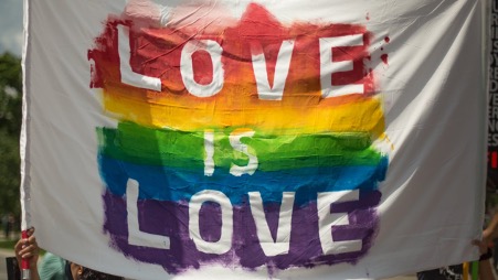 Pride Flag Colours saying "Love is Love"